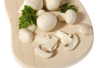 Portabello mushroom slices on wooden chopping board