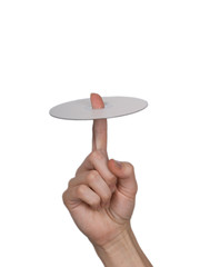 The female hand holds  a disk on a white background