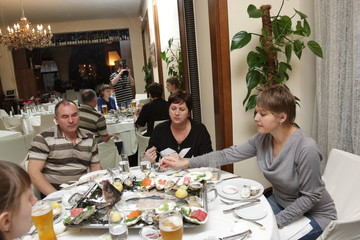 A family resting in a seafood restaurant