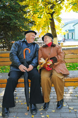 happy grandparent on bench in park