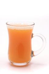 small transparent glass with orange juice