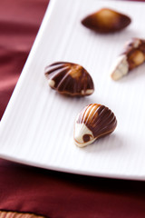 Four assorted chocolates laid out on a plate