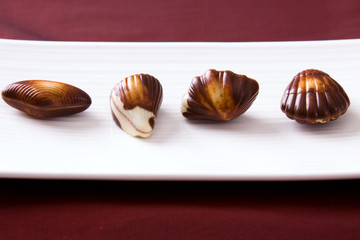 Four assorted chocolates laid out on a plate