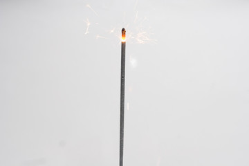 one christmas sparkler against the white background