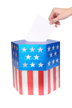 Hand casting vote into ballot box