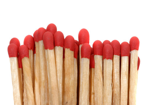 Set of red matches close up on white background