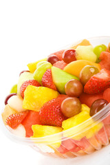 Delicious, colorful tropical fruit salad against a white