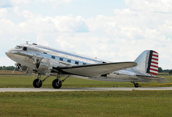 Fototapeta na wymiar Vintage silver colored turboprop airplane side view