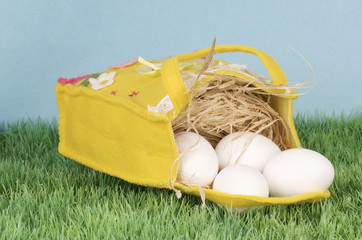 a decorative felt bag with eggs on grass