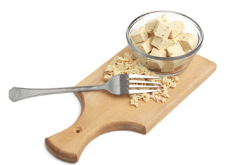 fresh fine herbs tofu in a bowl and wood plank with a fork