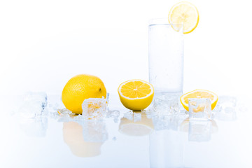 advertising still-life with glass of soda and lemons in ice