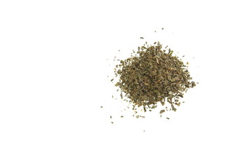 Small pile of dried basil herb on white