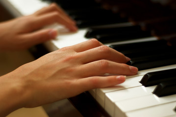 Young Girl's Hands Playing Piano