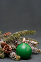 Christmas composition of conifer, cones and candle
