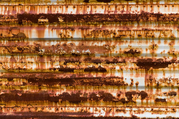 Horizontal rusty corrugated steel panel with rivots