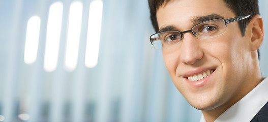 Portrait of young successful businessman at office