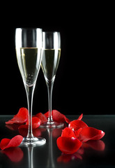 champagne glasses with petals of rose