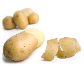 some yellow potatoes isolated on white background
