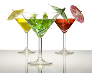 three cocktails with umbrella isolated on a white background