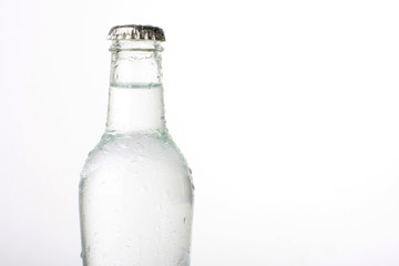 Bottled water with water drops, isolated on white