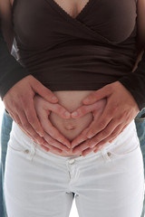 cropped shot of a pregnant womanhusband is holding her