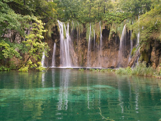 waterfalls cascading into a pond in Plitvice, Croatia