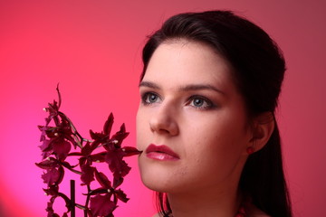 Fototapeta premium Young fashion model in studio with orchid