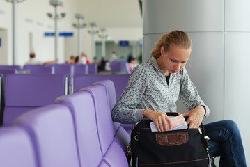 Woman at the airport witn tickets, shallow DOF