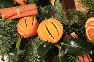 Close up of an oranges and cinnamon Christmas wreath.