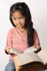 the little girl reading a dictionary book