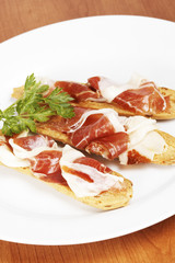 Spanish ham on white dish. Shallow depth of field