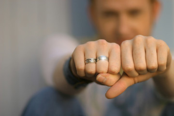 Detail of man's hand's wearing silver rings - 10292592