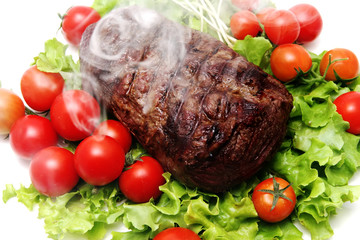 smoke meat and vegetables on transparent dish