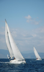 Obraz premium two white yachts sail in the sea