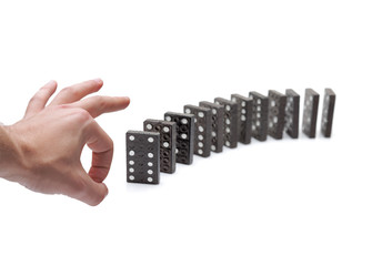 Person pushing domino blocks