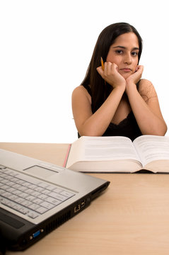 Young Hispanic woman sitting in front of desk