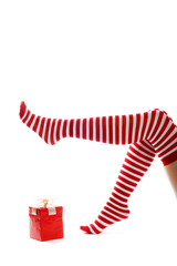 legs of a woman with socks and a gift isolated on white