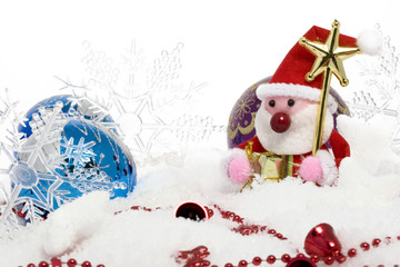 santa claus with christmas balls on snow
