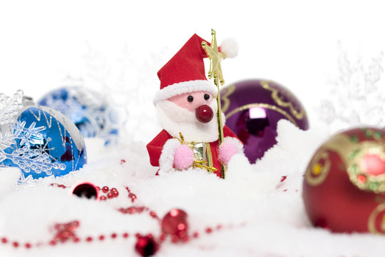 santa claus with christmas balls on snow