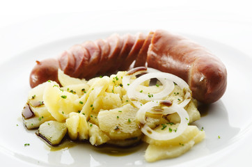Kransky sausage with boiled potato, onion and pumpkin oil