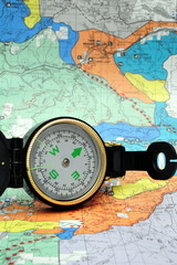 A black lensatic compass on hiking map