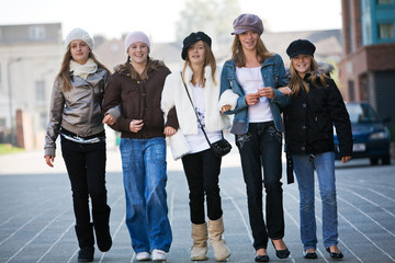A group of teenage walking towards the camera
