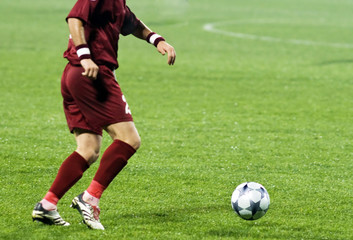 Soccer player running after the ball