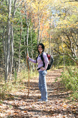 pretty teenage girl hiking outside in the fall