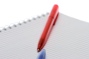 Pen and paper on a white background