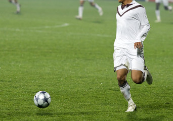 Soccer player running after the ball