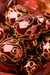 Pretty shiny red christmas baubles decorated with glitter