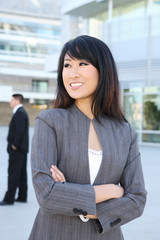 Young, beautiful asian business woman at office building