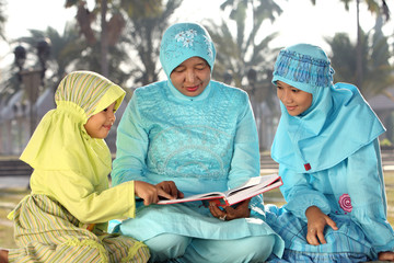 Muslim Mother and Kids Reading Qur'an