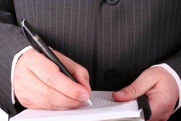 Businessman hand making notes